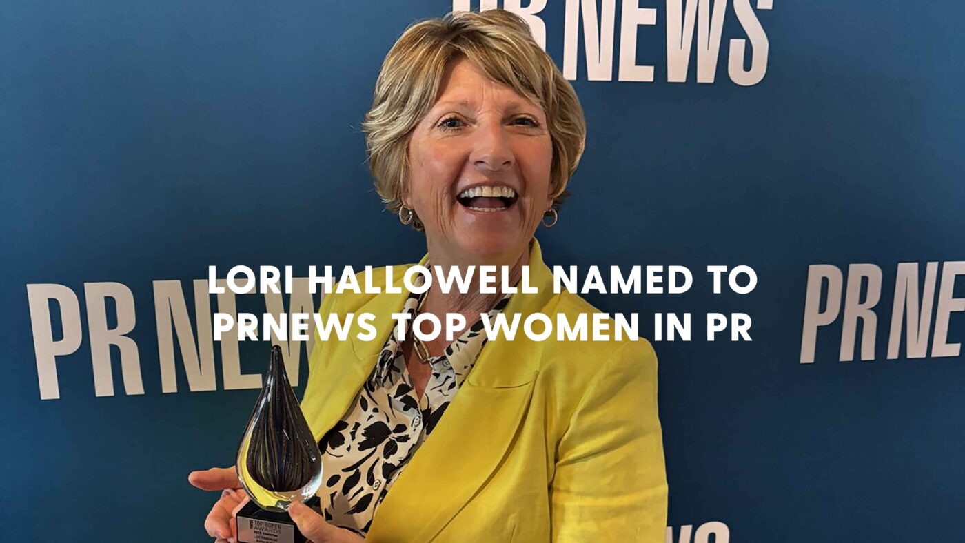 Lori Hallowell holding an award from PR News for being a top woman in PR.