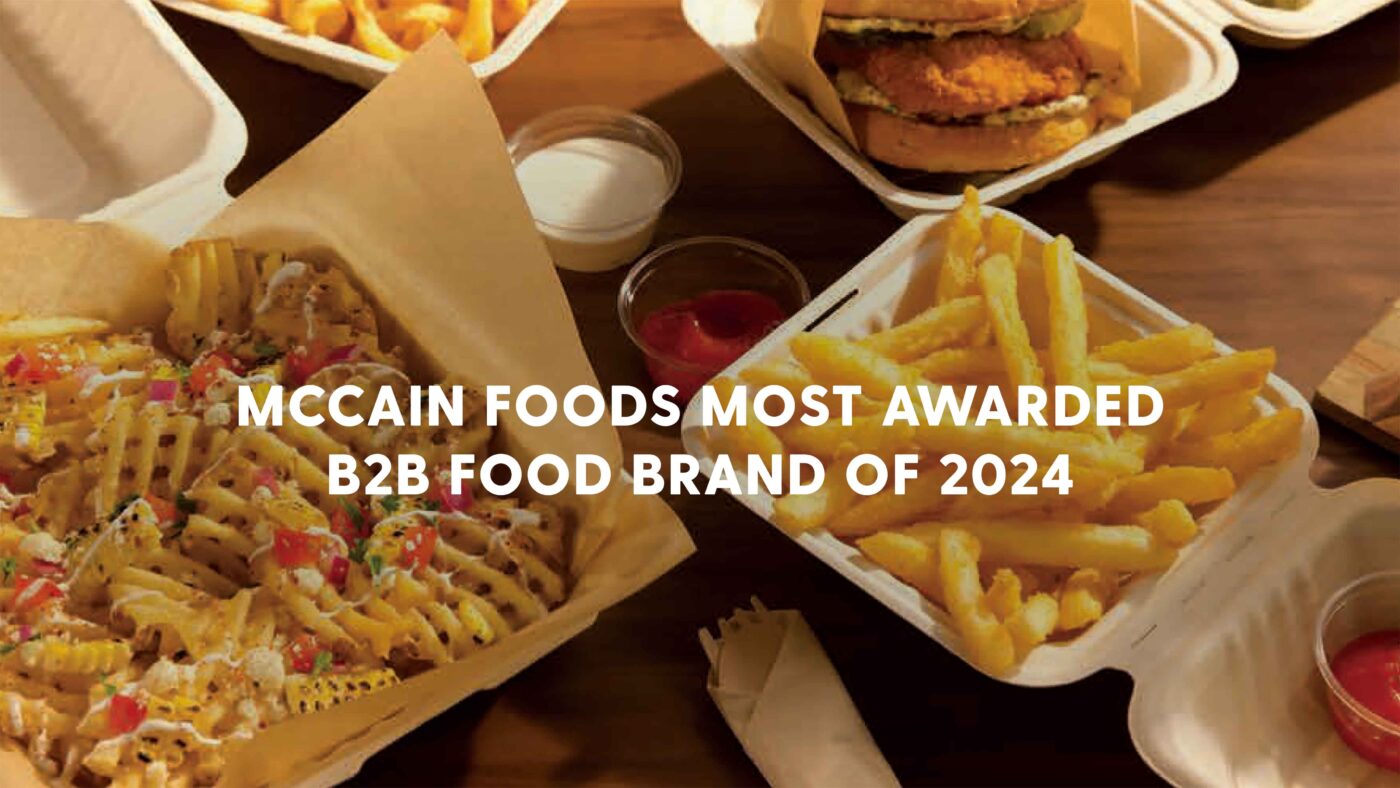 Assortment of fries, burgers and dipping sauces in takeout containers.